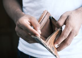 Close-up of hands holding an empty wallet, highlighting financial struggles and economic crisis.